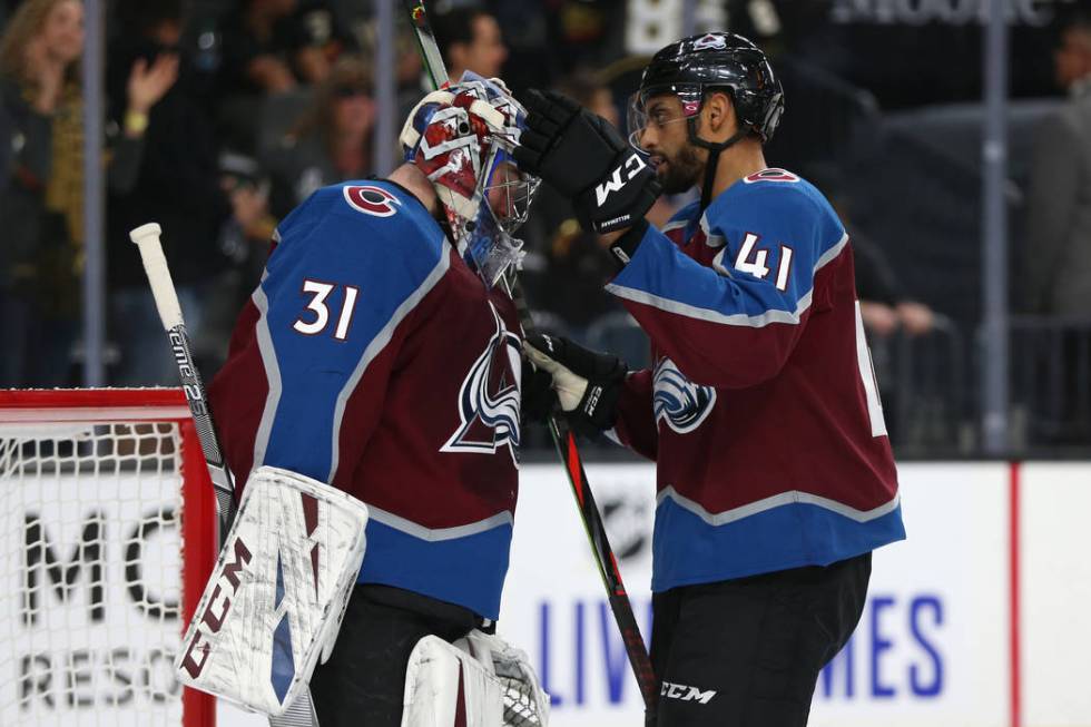 Colorado Avalanche goaltender Philipp Grubauer (31) and left wing Pierre-Edouard Bellemare (41) ...