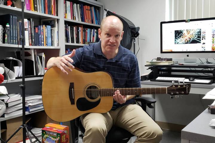 UNLV astrophysicist Jason Steffen in his office demonstrates the tonal differences between chor ...