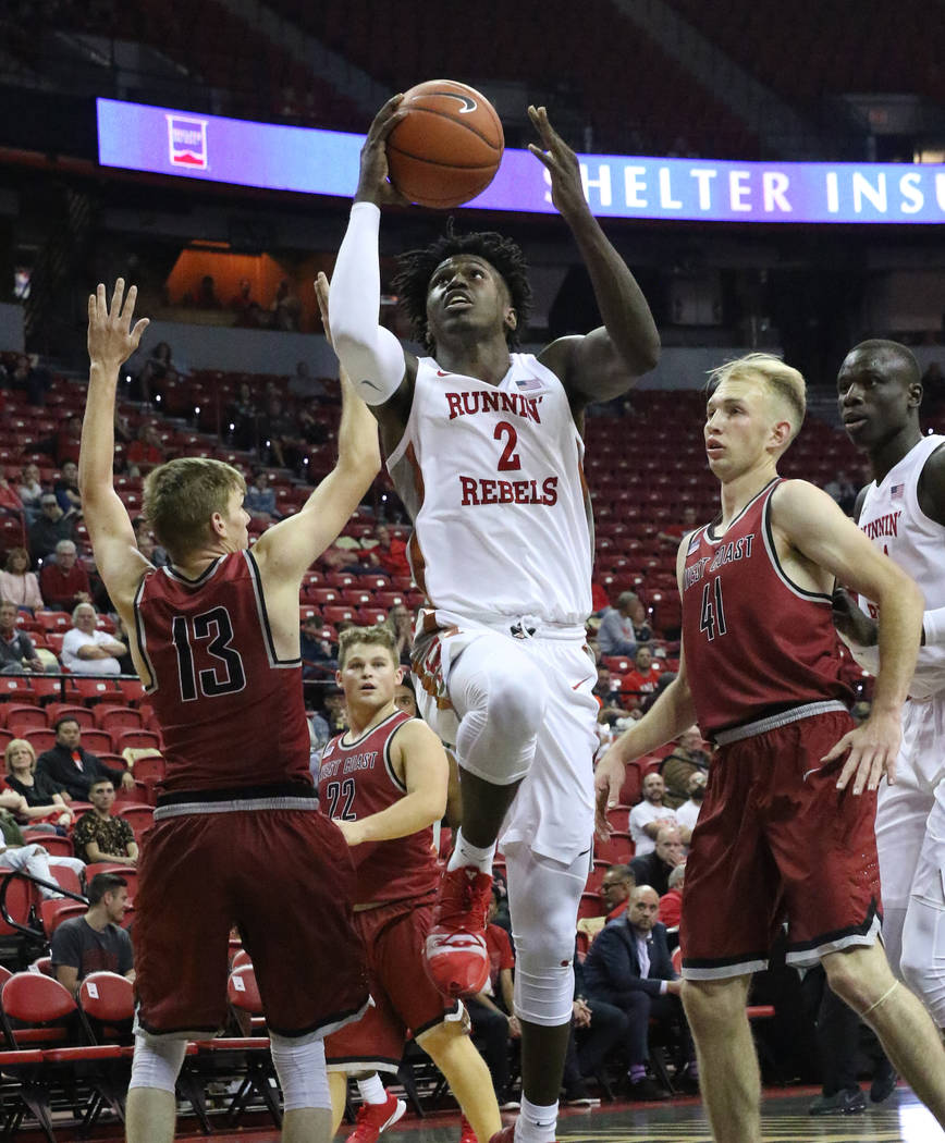 UNLV's forward Donnie Tillman (2) goes for the basket between West Coast Baptist guard Jacob Ma ...