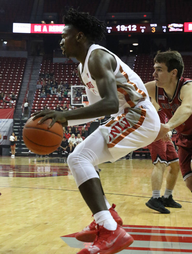 UNLV's forward Donnie Tillman drives past West Coast Baptist guard Andy Gilmer during the first ...