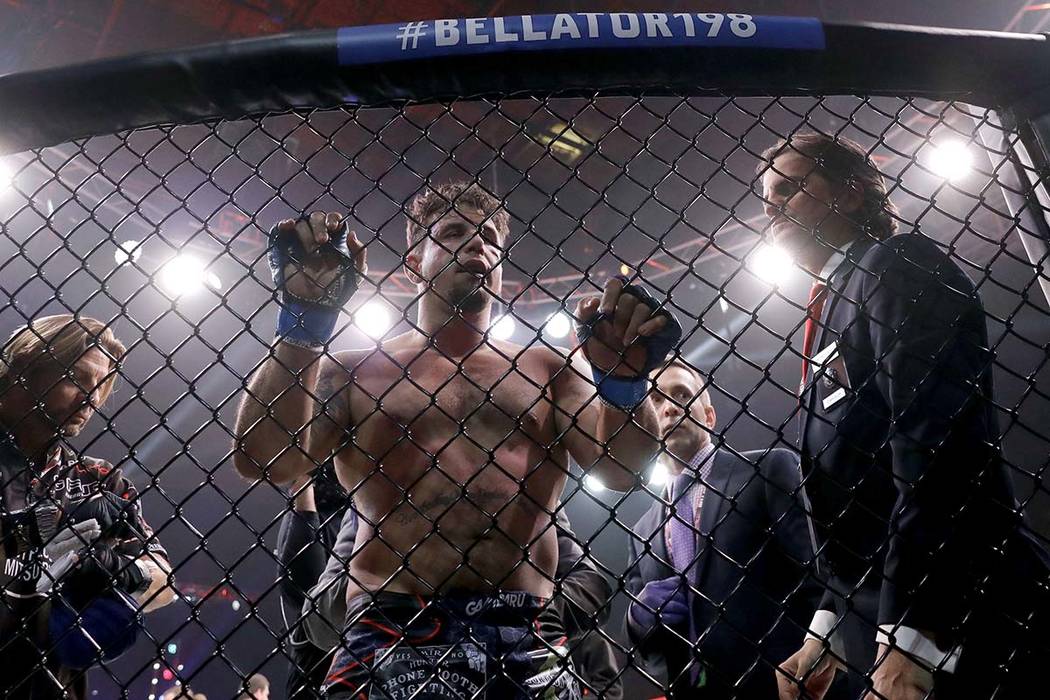 Frank Mir, center, reacts losing to Fedor Emelianenko, of Russia, in a heavyweight mixed martia ...