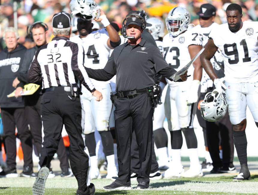 Oakland Raiders head coach Jon Gruden gestures to line judge Jeff Bergman (32) as his challenge ...