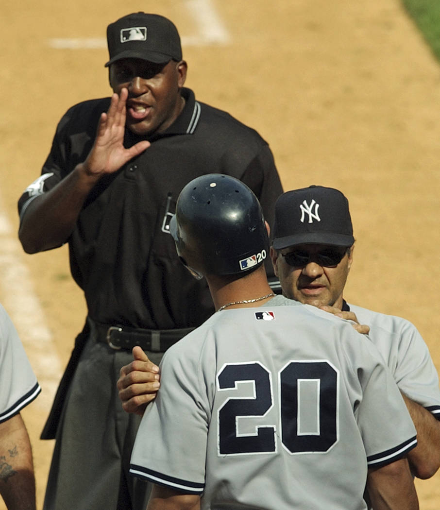 FILE - In this July 3, 2004, file photo, home plate umpire Chuck Meriwether, left, talks to New ...