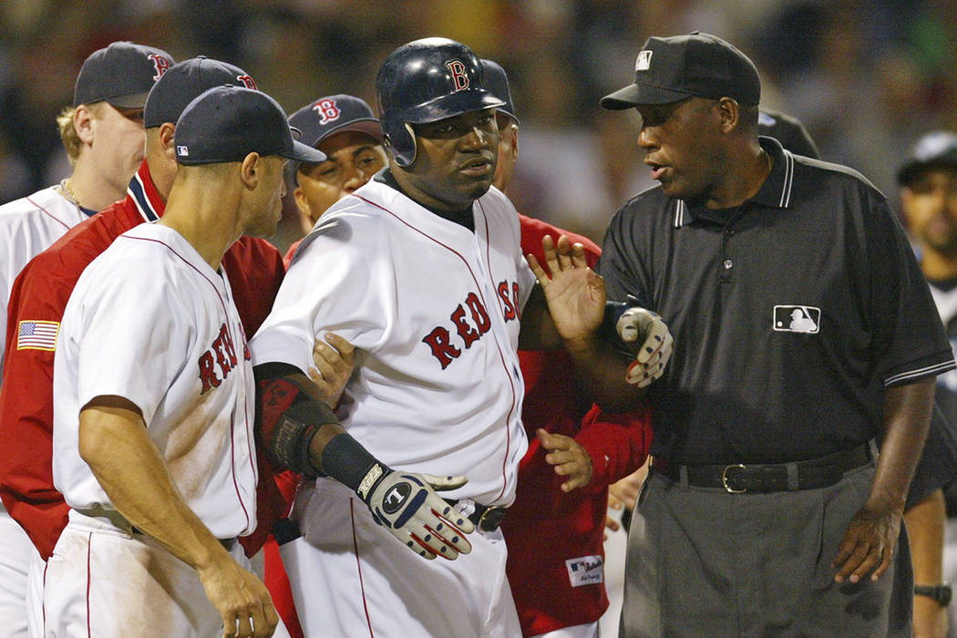 FILE - In this Aug. 17, 2004, file photo, Boston Red Sox David Ortiz, center, is restrained by ...