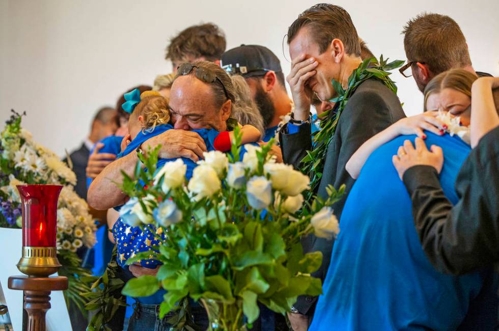 Sean Murray, center, weeps before the urn of his son Gavin Murray, 6, while surrounded by fami ...