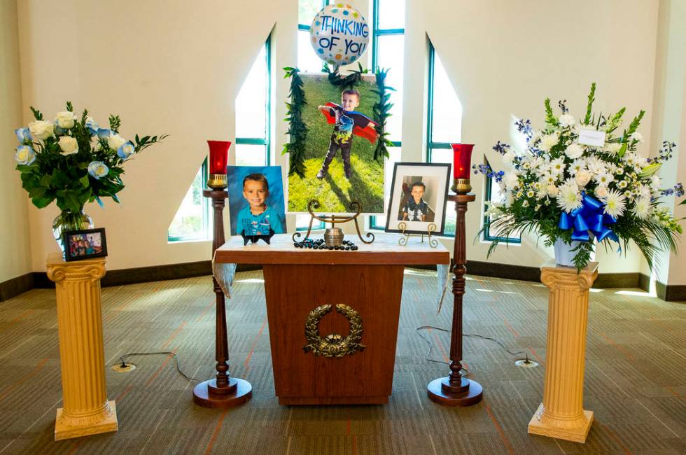 The urn and photos of Gavin Murray, 6, are presented before mourners during funeral services fo ...