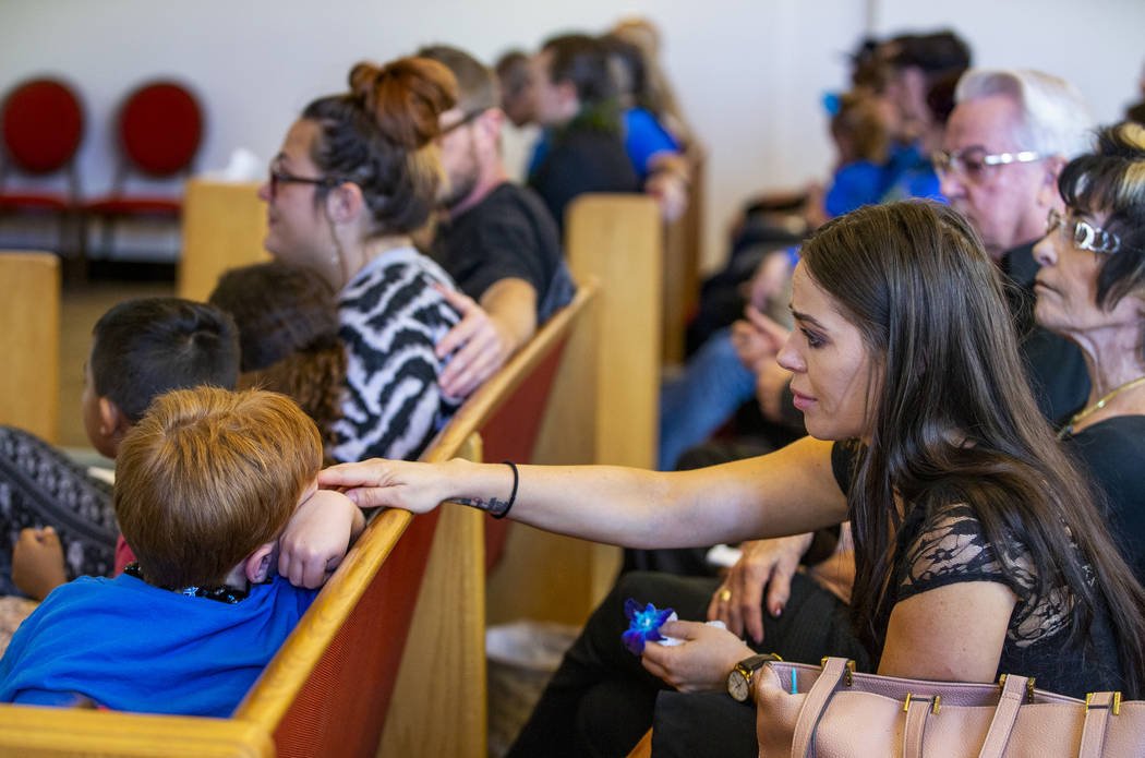 Christen Murray, right, connects with her son, Brayden, 7, during funeral services for family m ...