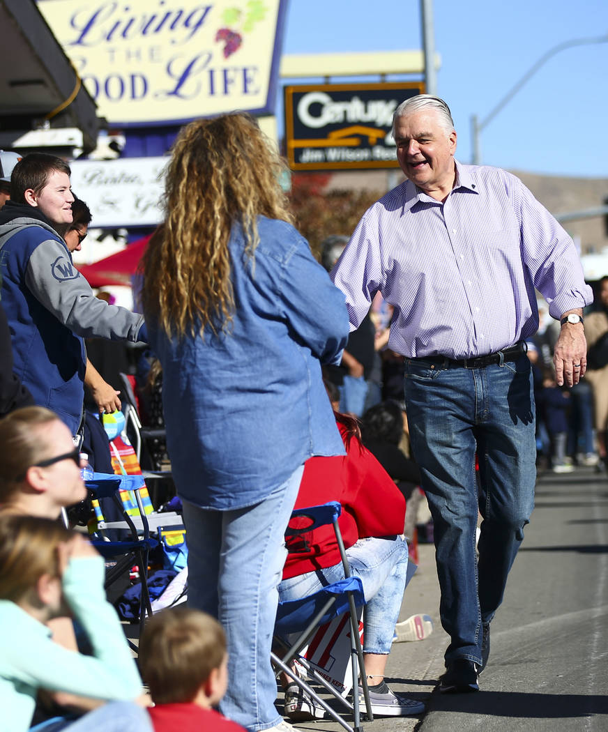 Gov. Steve Sisolak greets attendees during the annual Nevada Day Parade in Carson City on Satur ...