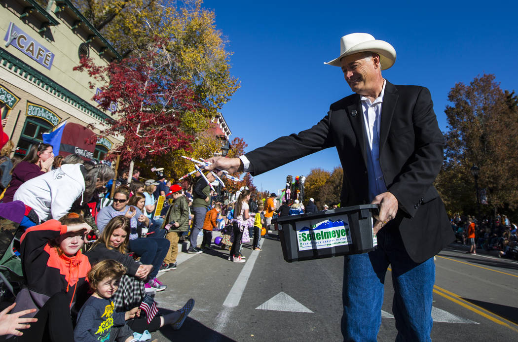 State Sen. James Settelmeyer hands out candy to attendees in the annual Nevada Day Parade in Ca ...