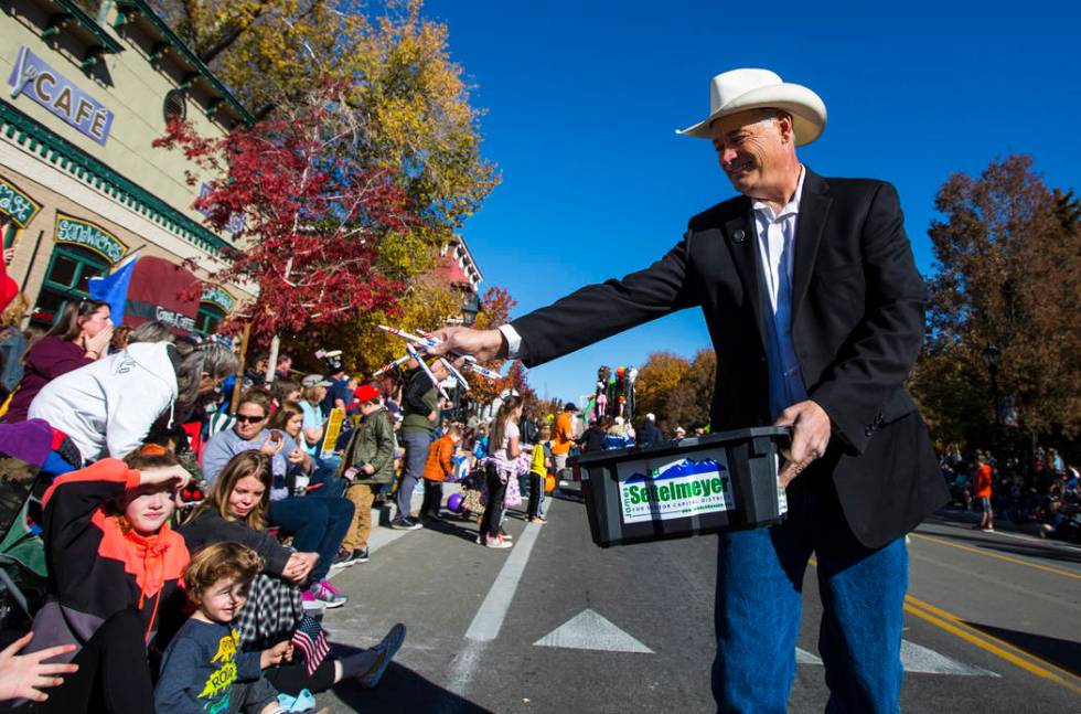 State Sen. James Settelmeyer hands out candy to attendees in the annual Nevada Day Parade in Ca ...