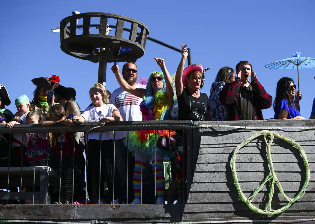 Attendees aboard the USS Nevada, a Burning Man art car, cheer during the annual Nevada Day Para ...