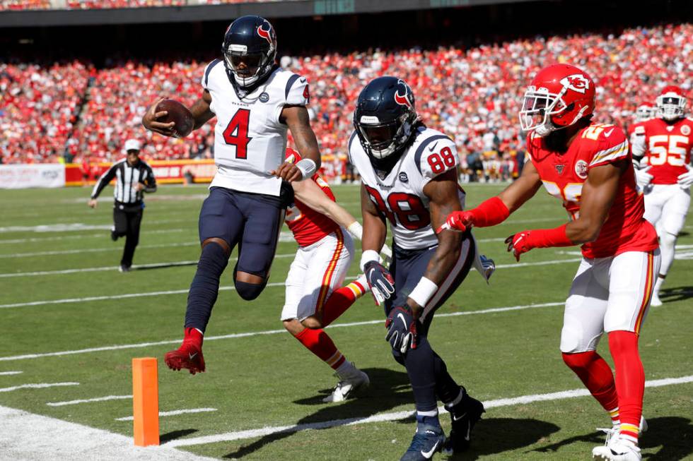 Houston Texans quarterback Deshaun Watson (4) scores a touchdown next to tight end Jordan Akins ...