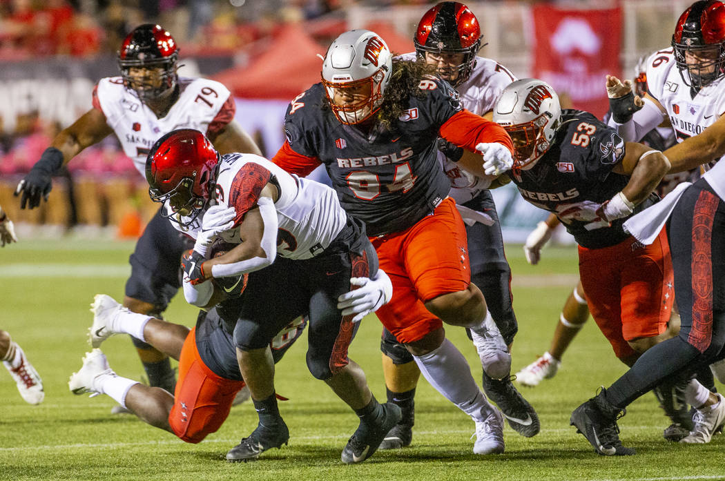 UNLV Rebels linebacker Rayshad Jackson (6) takes down San Diego State Aztecs running back Juwan ...