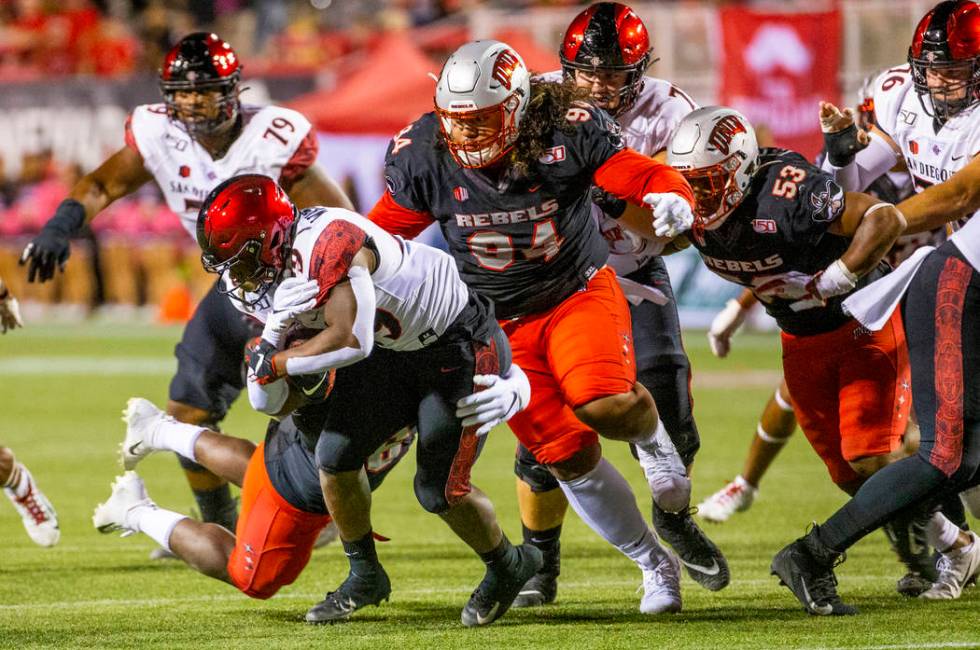 UNLV Rebels linebacker Rayshad Jackson (6) takes down San Diego State Aztecs running back Juwan ...