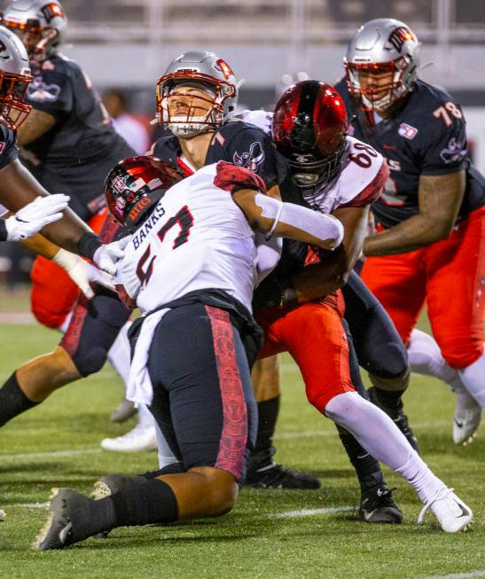 San Diego State Aztecs defensive linemen Keshawn Banks (57) and Myles Cheatum (68) team up to s ...