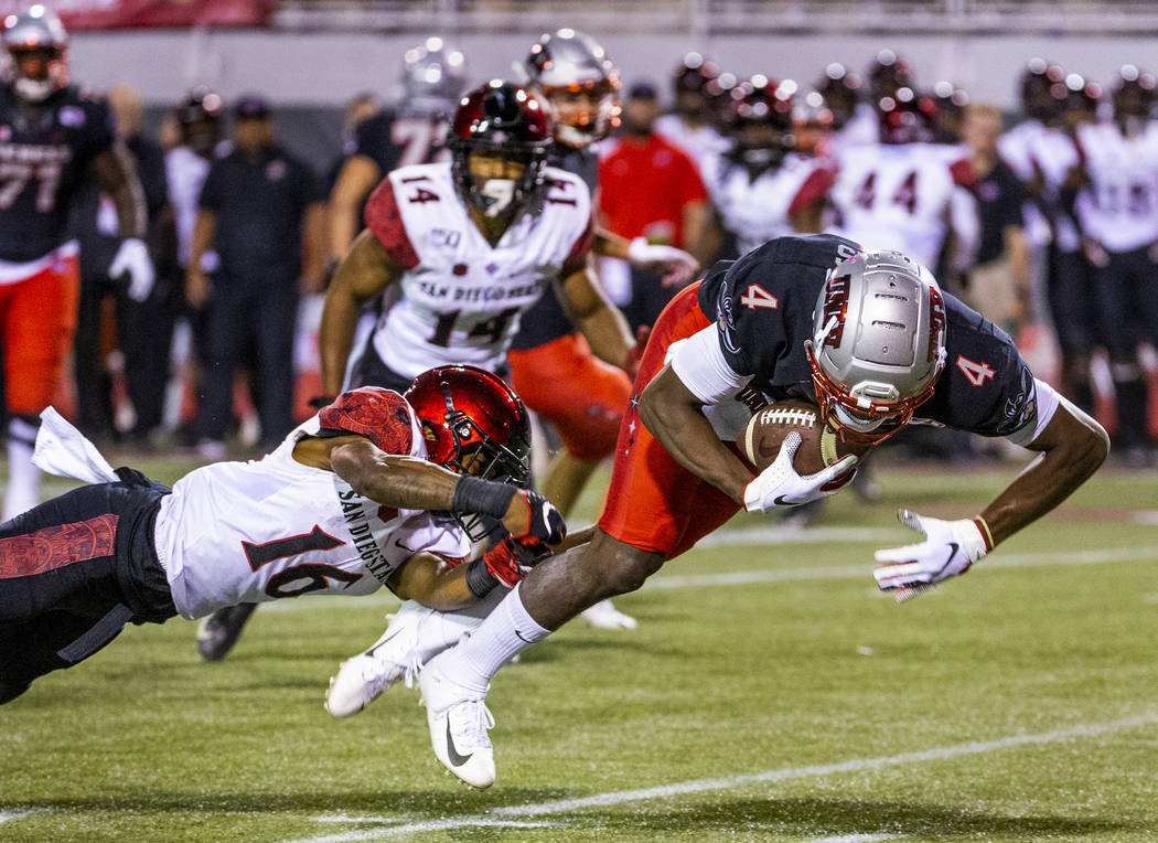 San Diego State Aztecs cornerback Luq Barcoo (16, left) is able to trip up UNLV Rebels wide rec ...