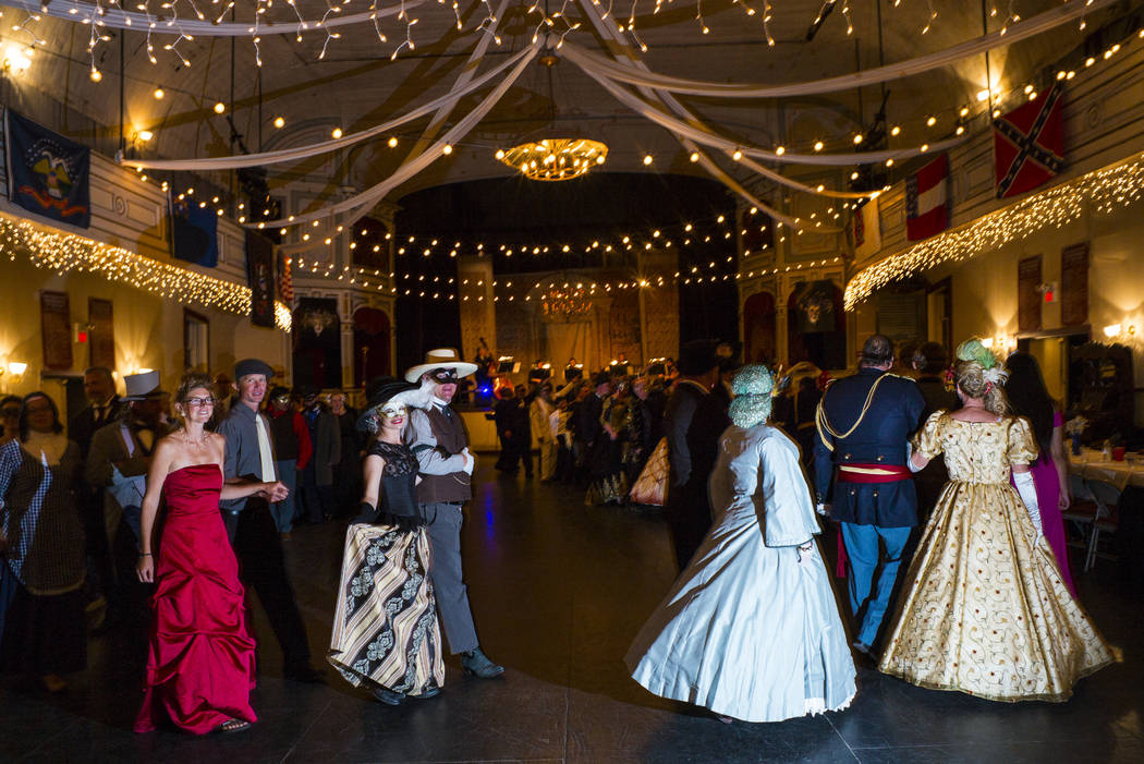 Attendees participate in the grand march during the Nevada Statehood Ball at Piper's Opera Hous ...