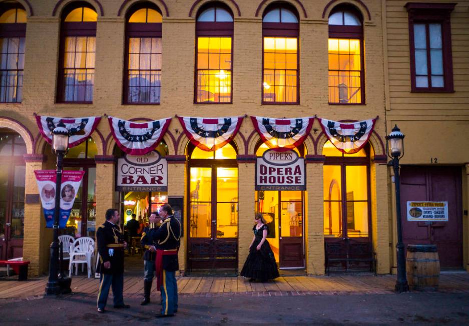 Attendees in period outfits chat outside Piper's Opera House before the start of the Nevada Sta ...