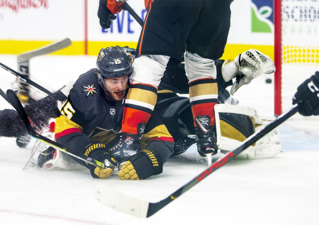 Vegas Golden Knights defenseman Jon Merrill (15) goes to the ice to help to deflect a shot on g ...