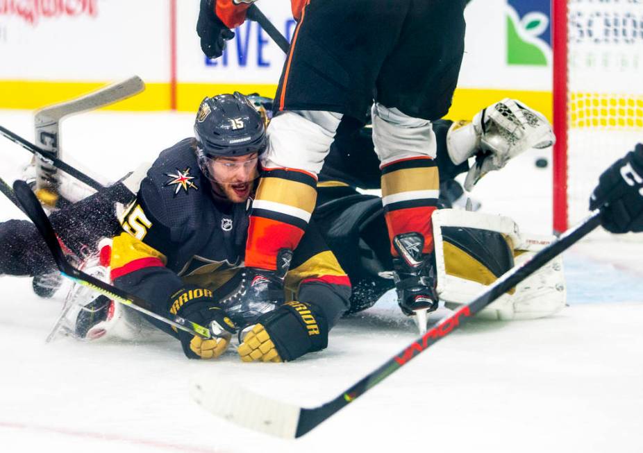Vegas Golden Knights defenseman Jon Merrill (15) goes to the ice to help to deflect a shot on g ...