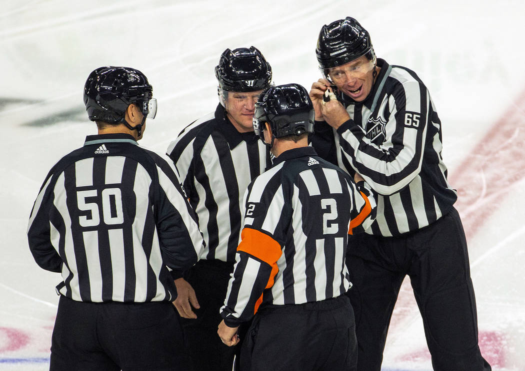 On ice officials come together as they ready to call the Vegas Golden Knights versus Anaheim Du ...