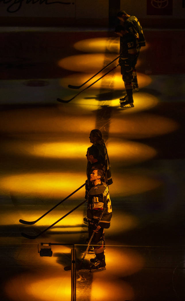 Vegas Golden Knights center Jonathan Marchessault (81) and teammates are bathed in golden light ...