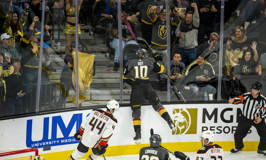 Vegas Golden Knights center Nicolas Roy (10) jumps into the glass while celebrating his first t ...