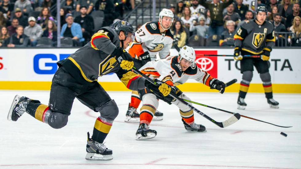 Vegas Golden Knights center Cody Eakin (21) fires a shot at goal past Anaheim Ducks defenseman ...