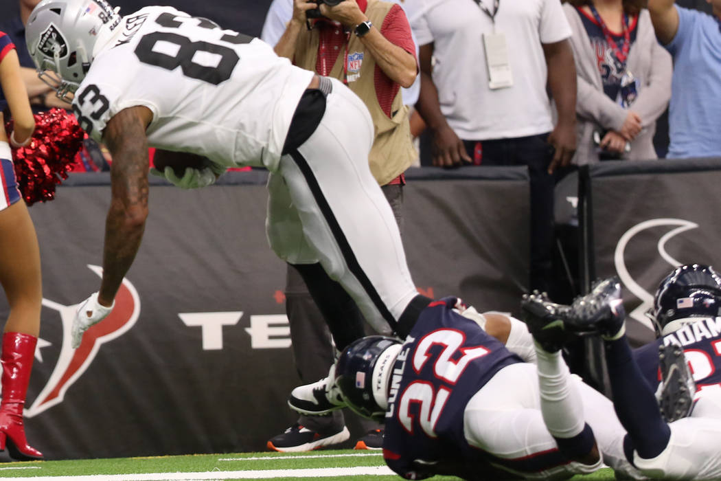 Oakland Raiders tight end Darren Waller (83) tries to shed a tackle from Houston Texans cornerb ...