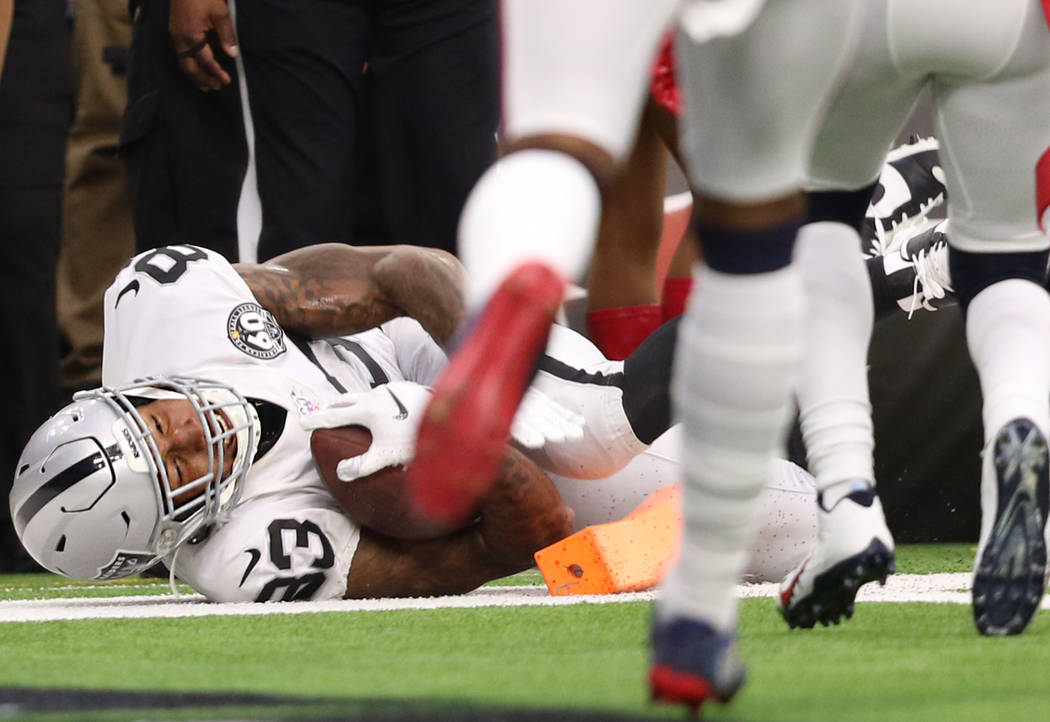 Oakland Raiders tight end Darren Waller (83) scores a touchdown during the first half of an NFL ...