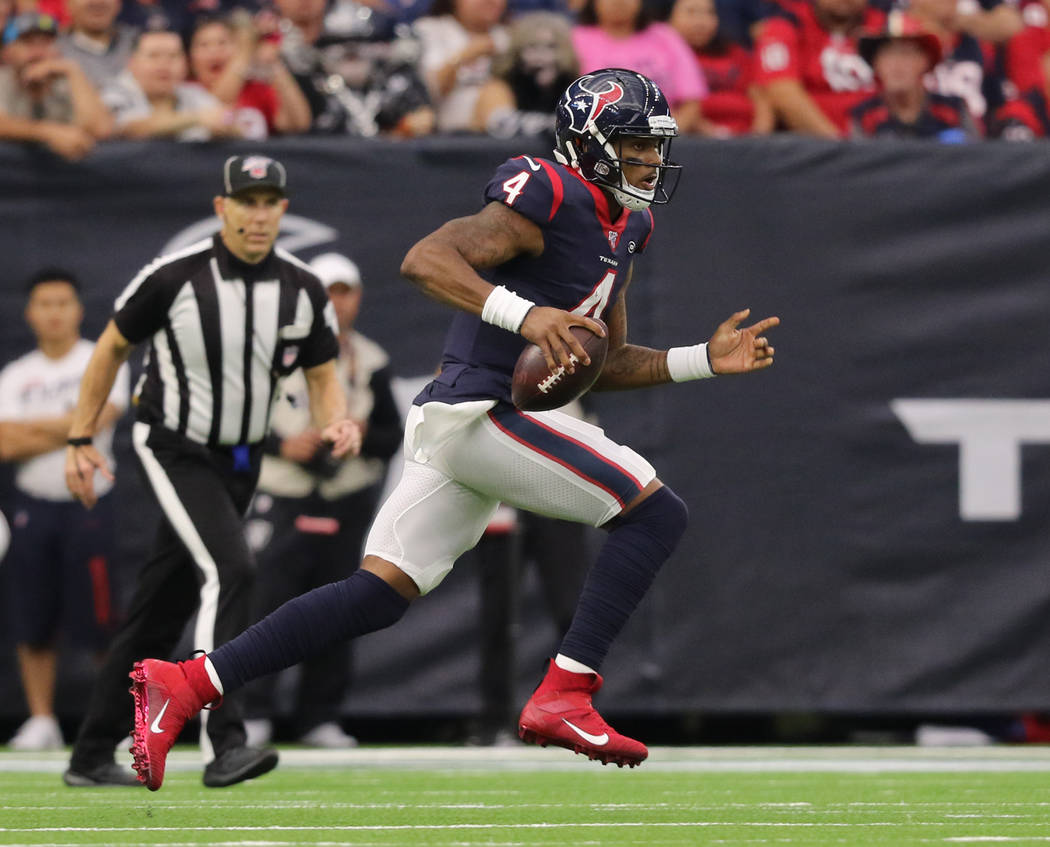 Houston Texans quarterback Deshaun Watson (4) runs with the football during the first half of a ...