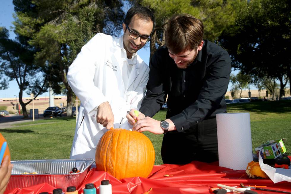 UNLV School of Medicine Internal Medicine Residents, Awad Javaid, left, and Jason Waldman carve ...