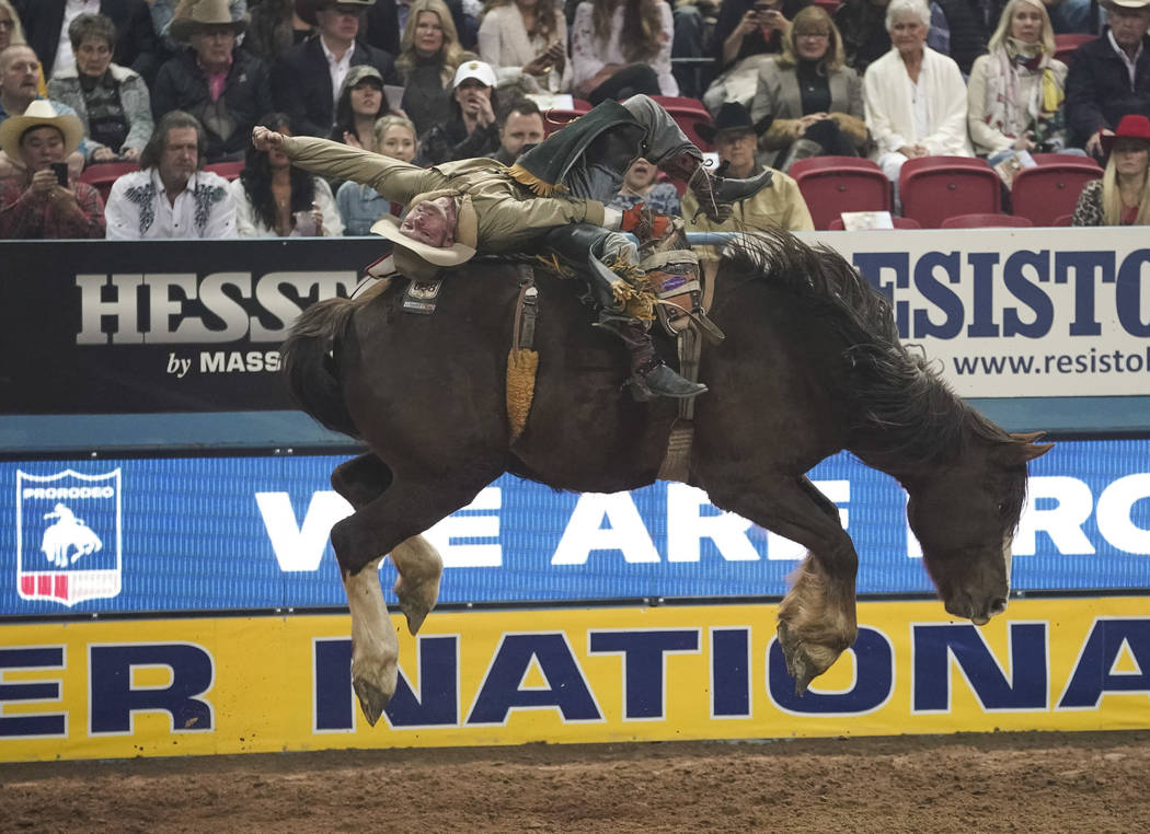 Will Lowe of Canyon, Texas (120) competes in the bareback riding event during the eighth go-rou ...