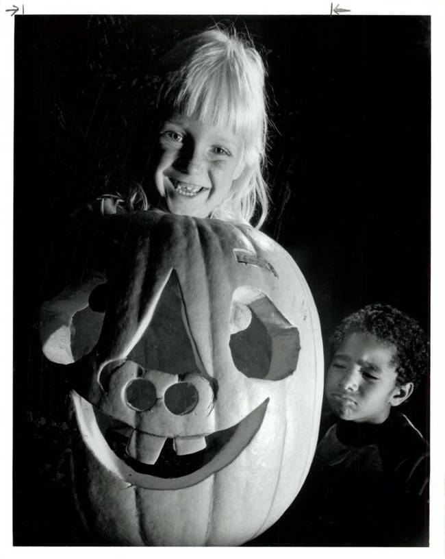 Lyn Maring, 6, grins, showing similar a dental arrangement of Halloween pumpkin and herself whi ...