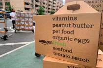 In this Sunday, June 16, 2019, photo, boxes of Amazon Fresh deliveries are unloaded. (AP Photo/ ...