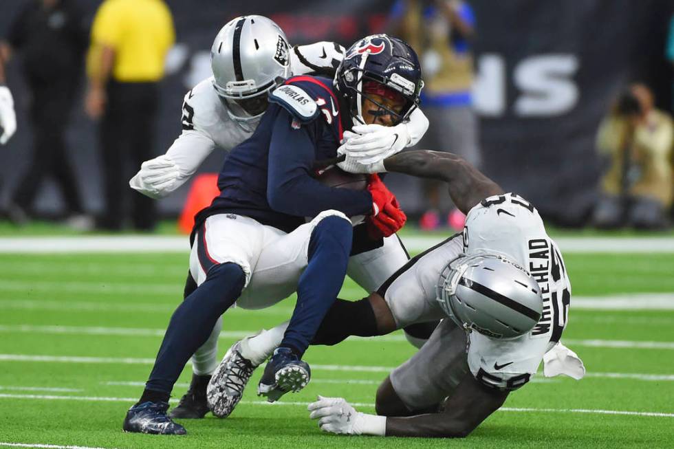 Houston Texans wide receiver DeAndre Hopkins (10) is hit by Oakland Raiders outside linebacker ...