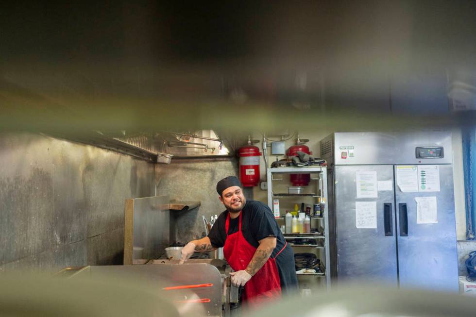 Crown & Anchor Pub line cook Jacob Trujillo works while sharing his three different encounters ...