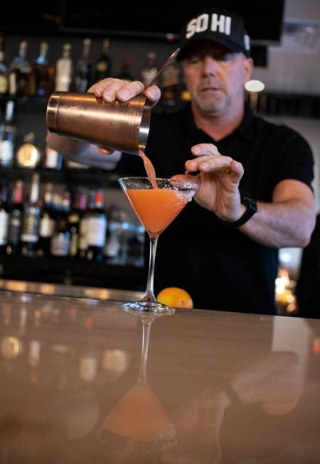 Bartender lead David Cooper pours a cocktail with fresh grapefruit juice and bitters at Spaghet ...