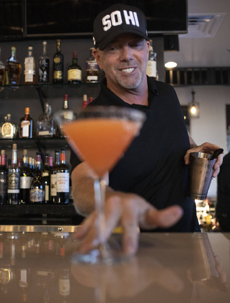 Bartender lead David Cooper pours an aperitif with fresh grapefruit juice and bitters at Spaghe ...