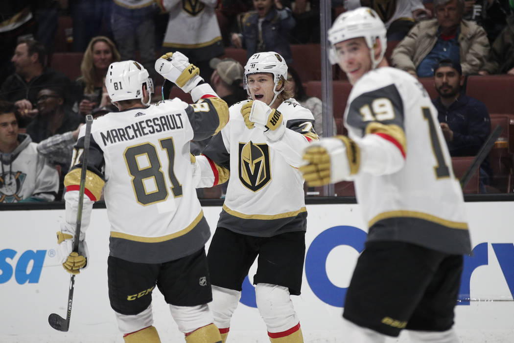 Vegas Golden Knights' William Karlsson, center, celebrates his goal with Jonathan Marchessault ...