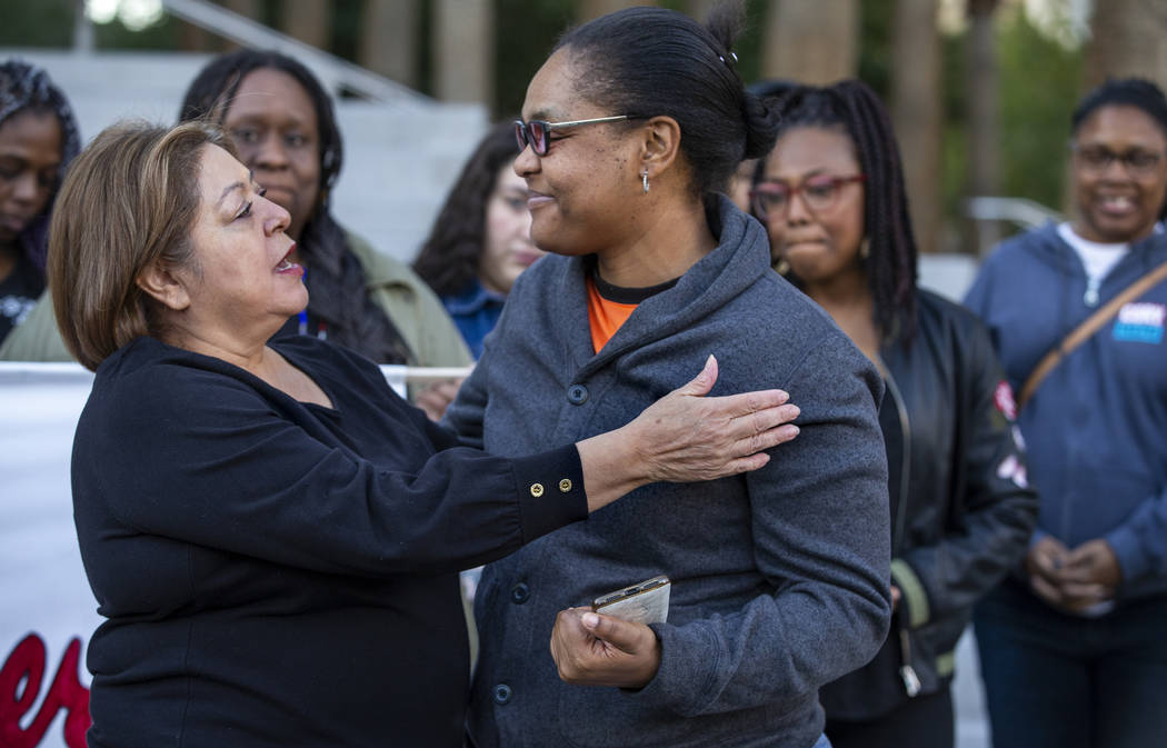 Alma Chavez, left, has some kind words for Kelly Williams speaking during the National Day of O ...