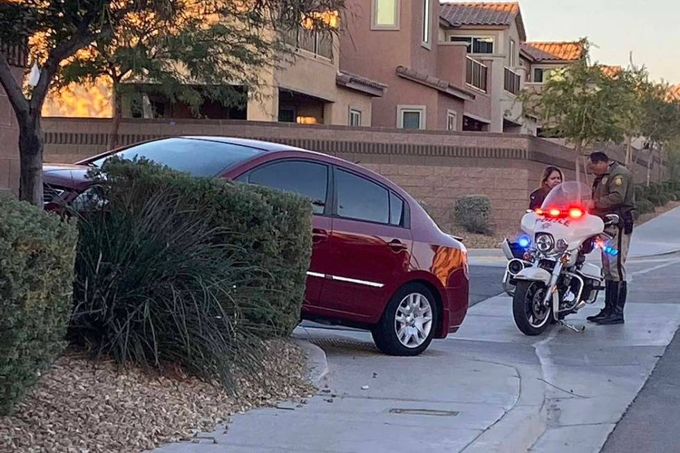 A police officer interviews a witness to an auto-pedestrian crash on Tuesday, Oct. 29, 2019, at ...