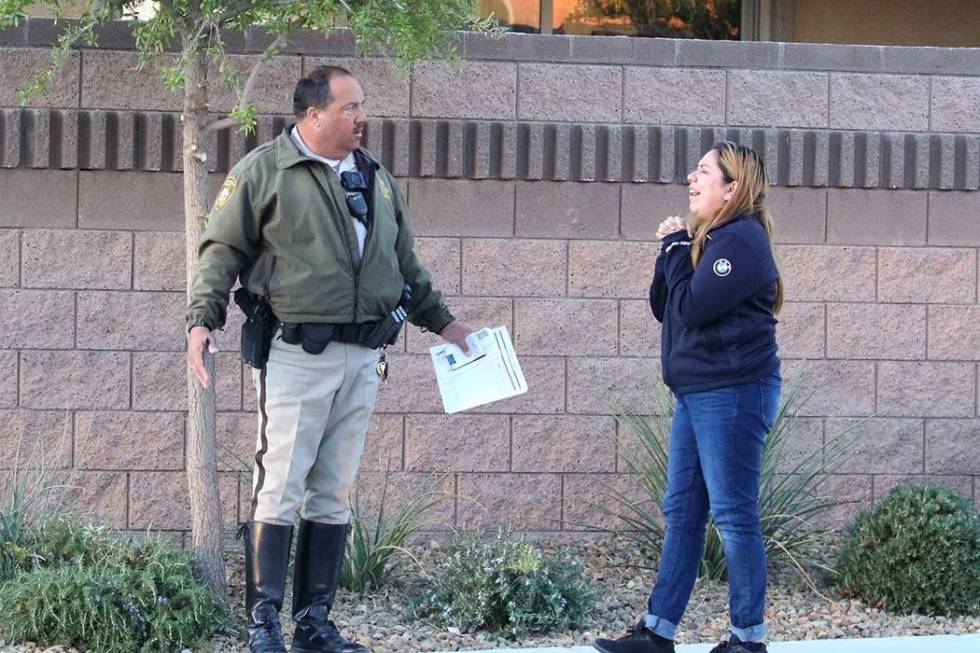 A Las Vegas police officer talks to one of the drivers involved in a two-car crash at West Ford ...