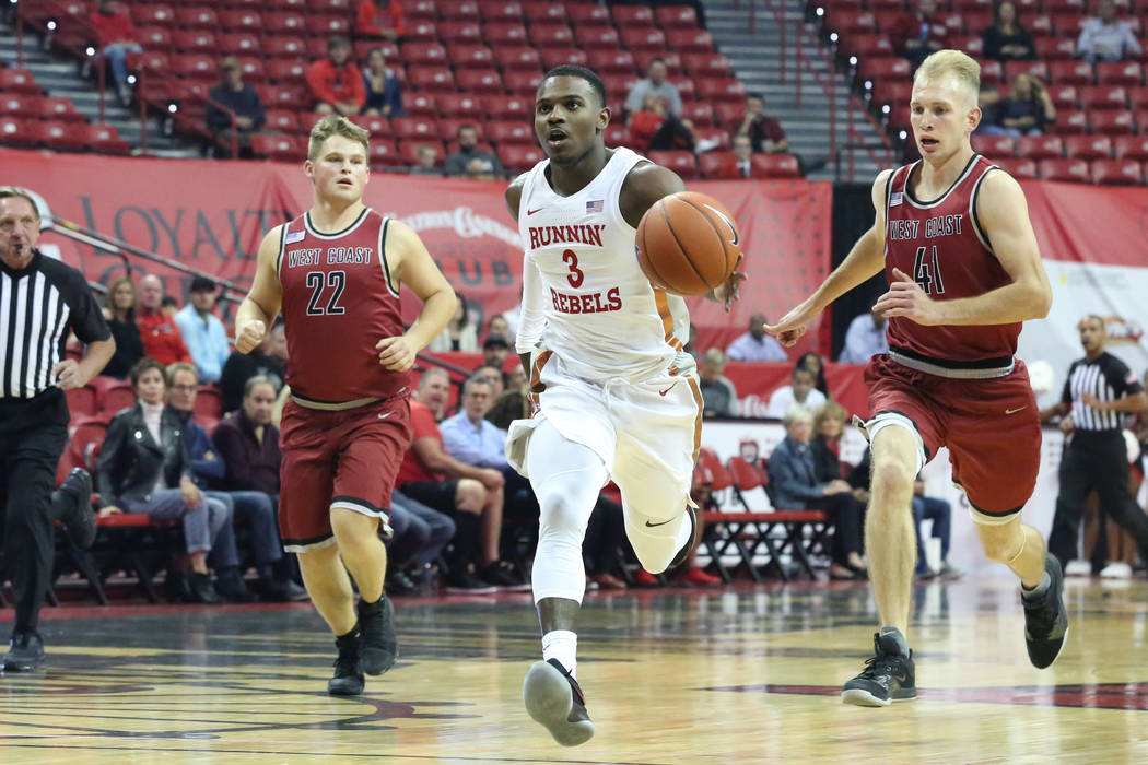 West Coast Baptist guard Seth Thomas Hanna (22) and Ian forward James Russell (41) chase UNLV's ...