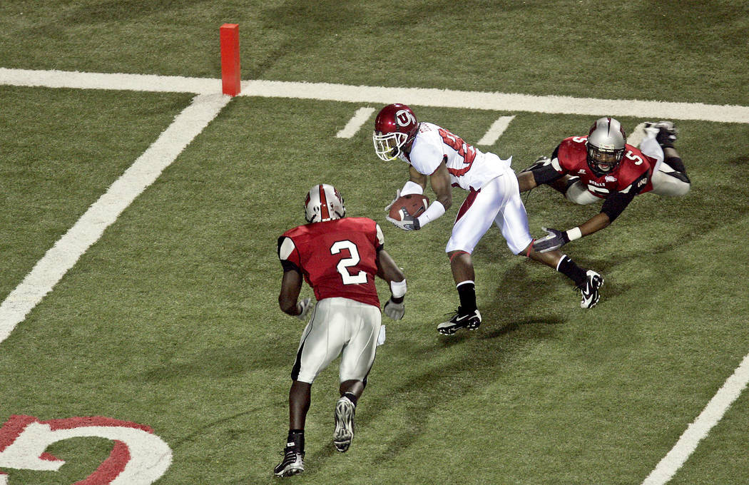 UNLV's Beau Bell (2) and Mil'Von James (5) work to take down Utah's Jereme Brooks two-yards fro ...