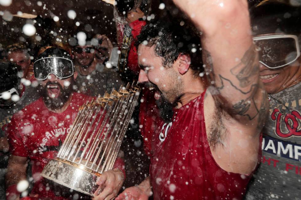 Washington Nationals third baseman Anthony Rendon and Adam Eaton celebrate in the locker room a ...