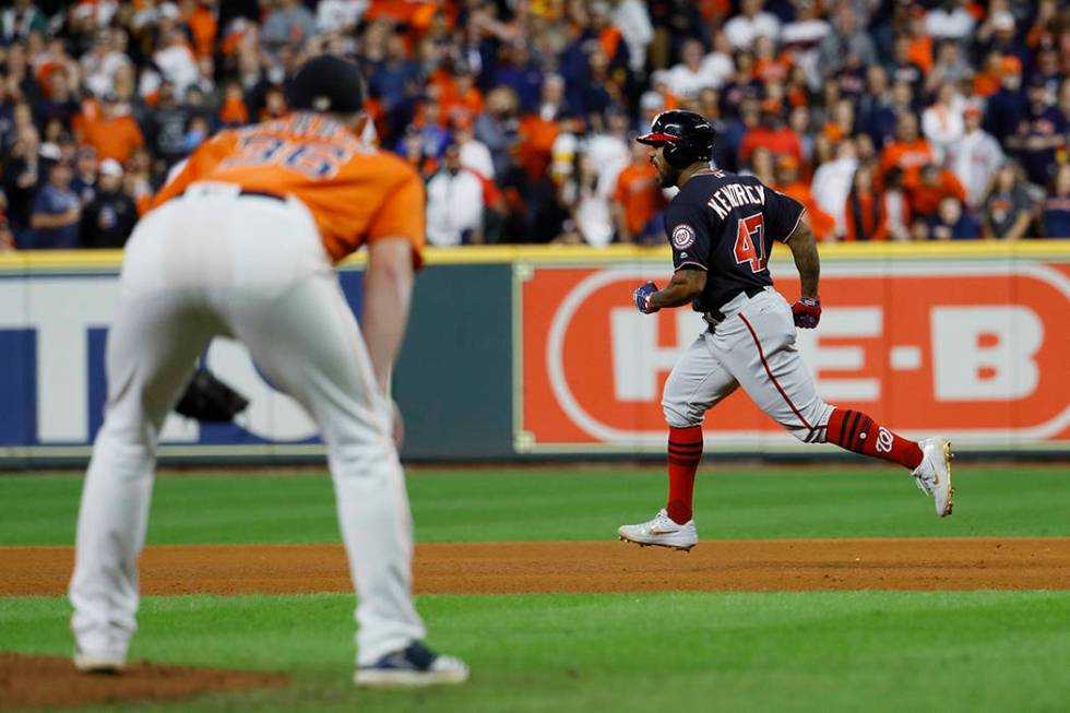 Houston Astros relief pitcher Will Harris watch as Washington Nationals' Howie Kendrick reacts ...