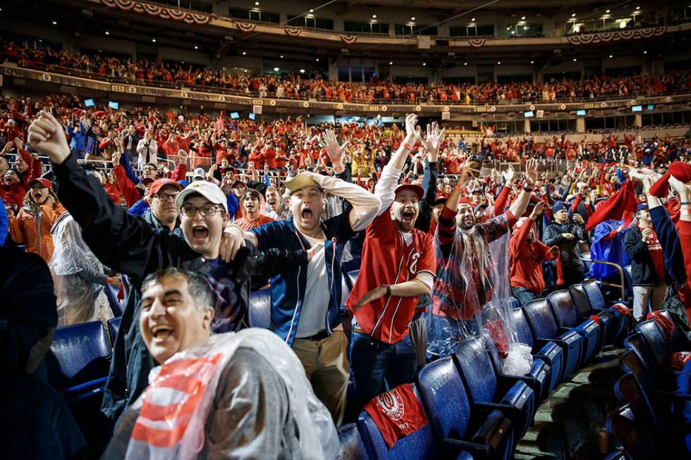 Washington Nationals fans celebrate at Nationals Park in Washington while watching television c ...