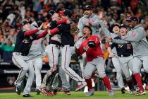 Washington Nationals' Yan Gomes and Daniel Hudson celebrate after Game 7 of the baseball World ...