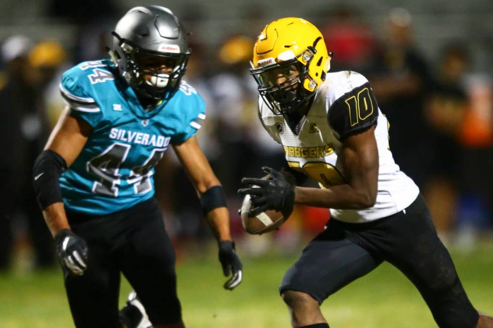 Clark's Dillan Lavender (10) runs the ball against Silverado's Chris Federico (44) during the f ...